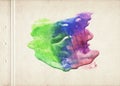 A sheet of old brown textured paper stained with asymmetrical green, blue and purple color watercolor paint blot. Fine vintage gru Royalty Free Stock Photo