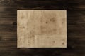 Sheet old vintage paper on the aged wooden background. Royalty Free Stock Photo