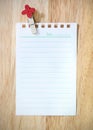 sheet of paper with clothespin on wood background Royalty Free Stock Photo