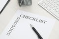 Sheet of paper with inscription Checklist and pen on white wooden table Royalty Free Stock Photo