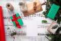 a sheet of paper lies on a white table next to gifts