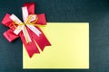 Sheet of paper with a ribbon on a black background Royalty Free Stock Photo