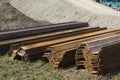 Sheet pile elements stacked and assembled in pairs at a bridge construction site