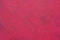 A sheet of pinkish-red decorative interlining fabric as background. The material used for creative scrapbooking works Royalty Free Stock Photo