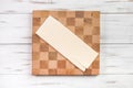 A sheet of raw dough on a cutting board in a cage. dough for making croissants. Light wooden background Royalty Free Stock Photo
