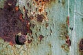 Sheet of rusty metal with cracked and flaky paint, a metal surface with a bolt Royalty Free Stock Photo