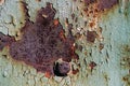 Sheet of rusty metal with cracked and flaky paint, a metal surface with a bolt, abstract rusty metal texture with cracked green pa Royalty Free Stock Photo