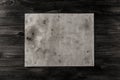 Sheet vintage paper on the aged wooden background. Parchment Royalty Free Stock Photo
