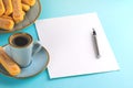 A sheet of white paper is empty on a blue background with an ink pen . Copy space. Royalty Free Stock Photo