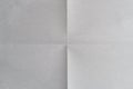 Sheet of white paper folded into four parts, paper texture background Royalty Free Stock Photo
