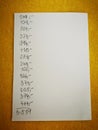A sheet of white paper with lines of handwritten numbers and their sum