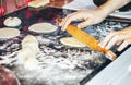 Female cook rolling dough with rolling-pin. Closeup view Royalty Free Stock Photo