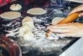 Female cook rolling dough with rolling-pin. Closeup view Royalty Free Stock Photo