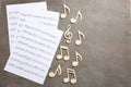 Sheets and music notes on color background, top view Royalty Free Stock Photo