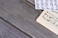 Sheets of musical notes on wooden background. Royalty Free Stock Photo