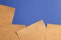 Sheets of old parchment paper on blue background, flat lay. Space for text Royalty Free Stock Photo