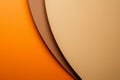 Sheets of orange, brown, and beige paper are overlapping, creating a visually appealing abstract composition with a variety of Royalty Free Stock Photo