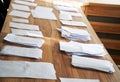 Sheets of paper collected during a poll, referendum, questionnaire or election, with the wishes of citizens, are on the table Royalty Free Stock Photo
