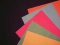 Sheets of paper of different colors on a black background Royalty Free Stock Photo