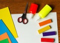 Sheets of paper, glue and scissors on a wooden table. Children's art project, a craft for children. Craft for kids. Royalty Free Stock Photo