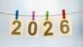 Sheets of paper with numbers hanging in row on a rope form the number 2026, which represents the new year Royalty Free Stock Photo