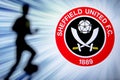 SHEFFIELD, ENGLAND, JULY. 1. 2019: Sheffield United Football club logo, Premier League, England. Soccer player silhouette Royalty Free Stock Photo