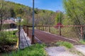 Sheffield, Pennsylvania, USA May 9, 2023 A metal walking bridge over Minister Creek from South Main Street Royalty Free Stock Photo