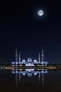 Sheikh Zayed Grand Mosque illuminated at full moon night Royalty Free Stock Photo