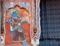 Naive fresco with indian maharajah king with royal crown on historical wall in India