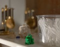 Shelf in the bathroom. the frog is a green toy with a funny face. a razor and shaving cream brush are visible. Royalty Free Stock Photo