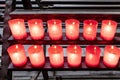 Shelf with burning offering candles Royalty Free Stock Photo