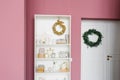 Shelf with Christmas decor in a pink colored living room and hallway