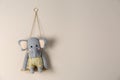 Shelf with cute toy elephant on wall, space for text. Child`s room interior element Royalty Free Stock Photo