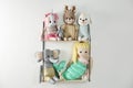 Shelf with cute toys on wall. Baby room interior element Royalty Free Stock Photo