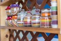 A shelf with different coloured spices