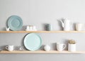 Shelf with dishes. Kitchenware on wooden shelves. Various food ingredients and utensils on kitchen shelves. Kitchen interior