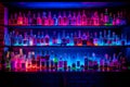 Shelf filled with lots of bottles of different types of alcohol in different colors. Generative AI