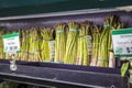 a shelf filled with organic asparagus for $6.99 each at the vegan market in Atlanta Georgia