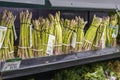 a shelf filled with organic asparagus for $6.99 each at the vegan market in Atlanta Georgia
