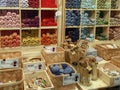 A shelf full of colorful balls of yarn in a shop with various accessories in the foreground Royalty Free Stock Photo