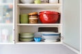 Shelf with plates, bowls and cups at home
