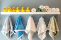 shelf with rubber ducks and hooded baby towels