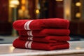 On the shelf is a set of red terry towels for spa treatments