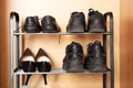 A shelf with shoes in the closet, sneakers, sneakers and shoes are on the shelf in the hallway, women`s worn shoes