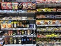 Shelf in a supermarket with food, chips, sauces and products from Asia.