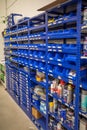 Shelf wall with various spare parts is located in a car workshop