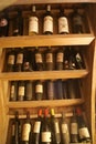 Shelf in wine cellar with old and dusty wine bottles