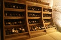 Shelf in wine cellar with old and dusty wine bottles