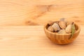 Shell almonds in wooden bowl on wooden table Royalty Free Stock Photo