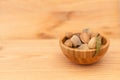 Shell almonds in wooden bowl on wooden table Royalty Free Stock Photo